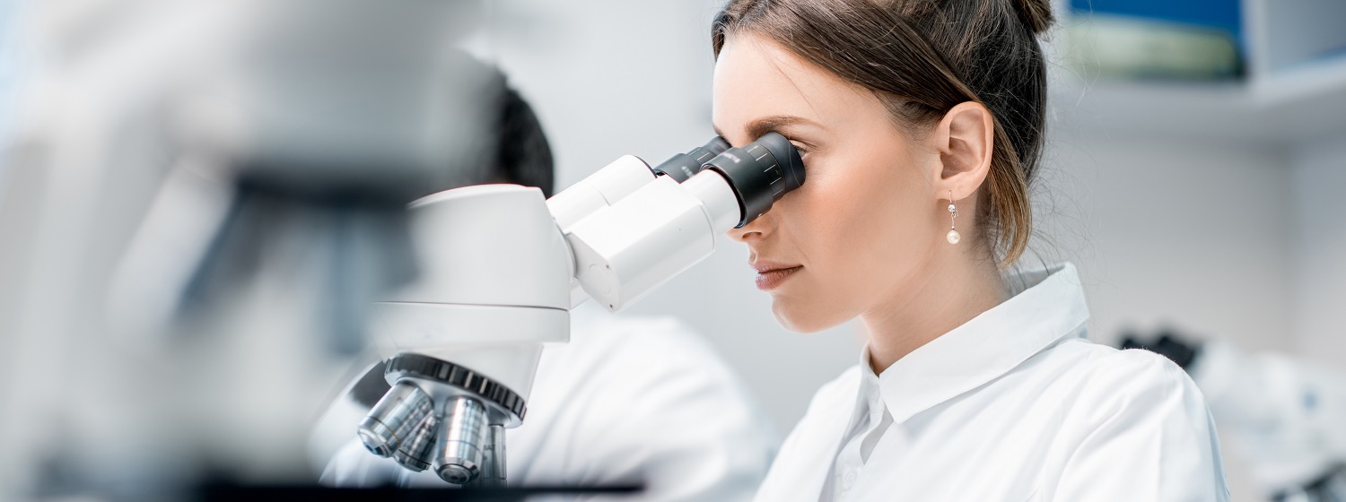 Medic working with microscope at the laboratory